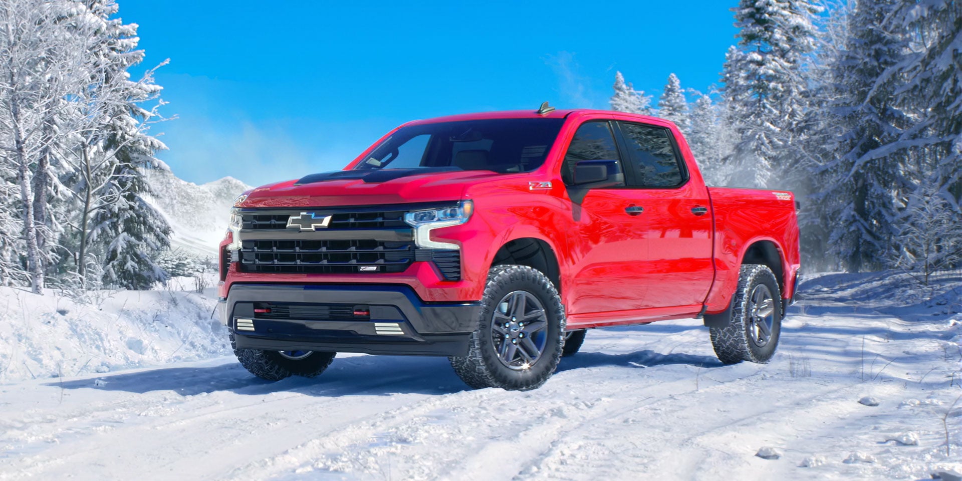 Image of a red 2022 Chevrolet Silverado 1500 driving on the icy road in the woods